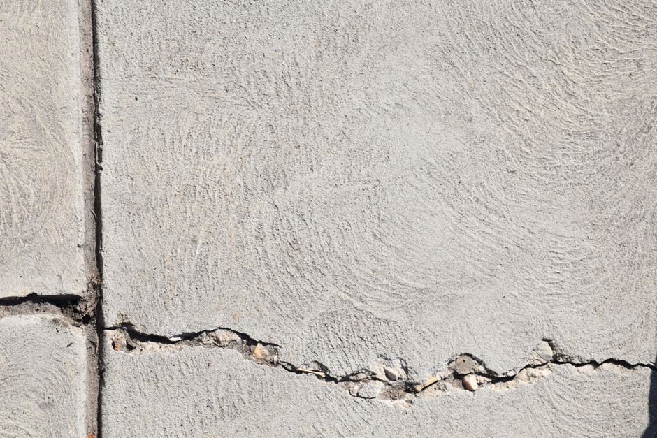 Close-up view of a cracked concrete surface with distinct textures in Logan, Utah.